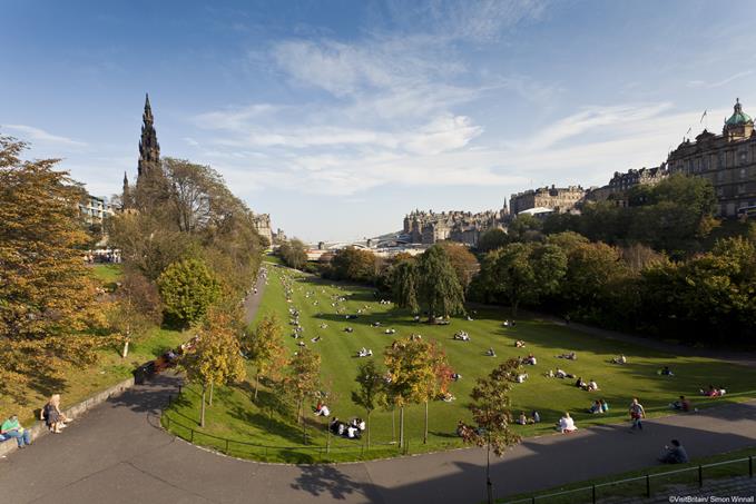 A day out in Edinburgh. A view from above of the Princes Street gardens, a public park.  View of the city