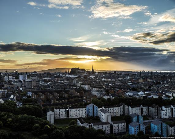 View of the Edinburgh skyline from Salisbury Crags at sunset. Footpath along the cliffs at the top of a subsidiary spur of Arthur