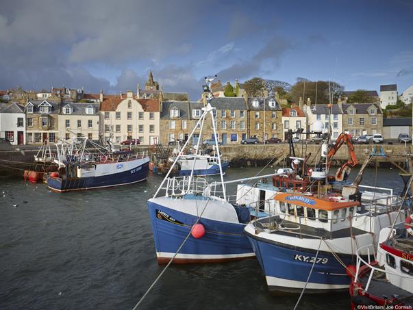  Fife Coastal trail. Pittenweem village and active fishing port. Protected harbour on the Fife coast, with large fishing boats at anchor by the harbour wall.
