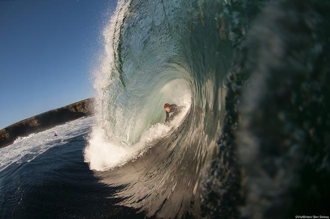 Surfer Rick Wilmet holds on tight whilst being enveloped by a tube wave in West Merkel, Caithness.