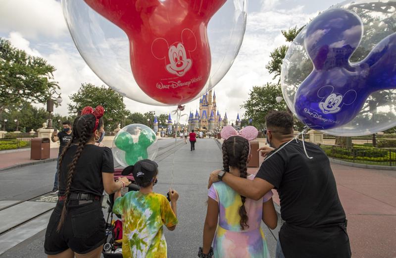Guests walk down Main Street, U.S.A. at Magic Kingdom Park, July 11, 2020, at Walt Disney World Resort in Lake Buena Vista, Fla., on the first day of the theme park’s phased reopening. (Kent Phillips, Photographer)