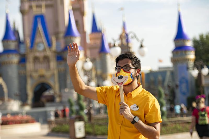 A Disney cast member welcomes guests to Magic Kingdom Park, July 11, 2020, at Walt Disney World Resort in Lake Buena Vista, Fla., on the first day of the theme park’s phased reopening. (Matt Stroshane, photographer)