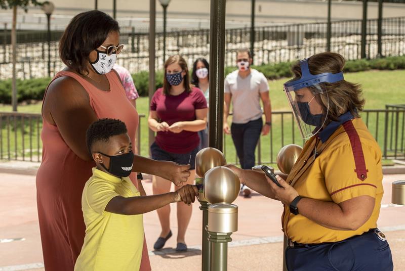 Cast members who continuously interact with guests at Walt Disney World Resort theme parks in Lake Buena Vista, Fla., such as seen here at the main entrance of Magic Kingdom Park, will wear both face coverings and face shields when the theme parks begin their phased reopening July 11, 2020. (Kent Phillips, photographer)