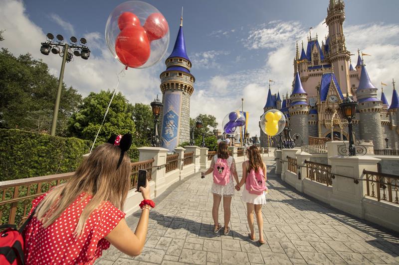 Guests stop to take a photo at Magic Kingdom Park, July 11, 2020, at Walt Disney World Resort in Lake Buena Vista, Fla., on the first day of the theme park’s phased reopening. (Kent Phillips, Photographer)