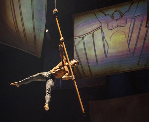 Celebrating the “pencil test,” an acrobat guides an aerial pole, stylized as a giant pencil, across the stage to create their own animation before propelling dramatically into the air during Drawn to Life, the highly anticipated new collaboration from Cirque du Soleil and Disney. The show premiered Nov. 18, 2021, at Walt Disney World Resort in Lake Buena Vista, Fla.  (Kent Phillips, photographer).